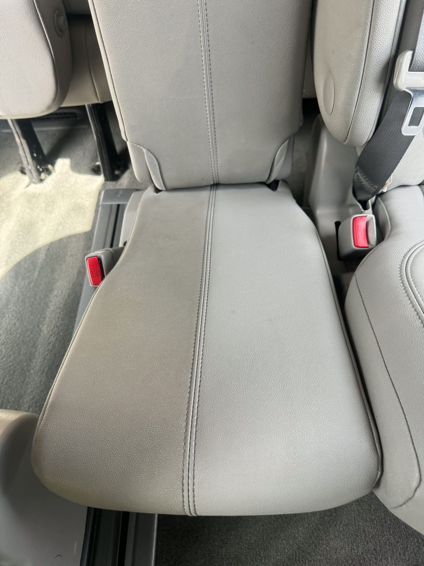 Grey leather rear bench seats cleaned during interior detailing
