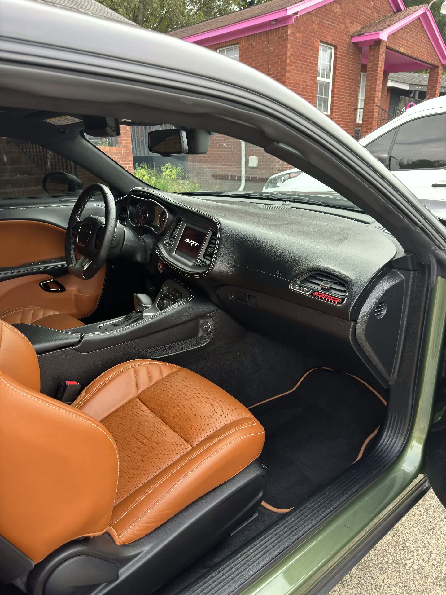 Passenger view of a Dodge Challenger SRT interior with brown leather and cleaned dash
