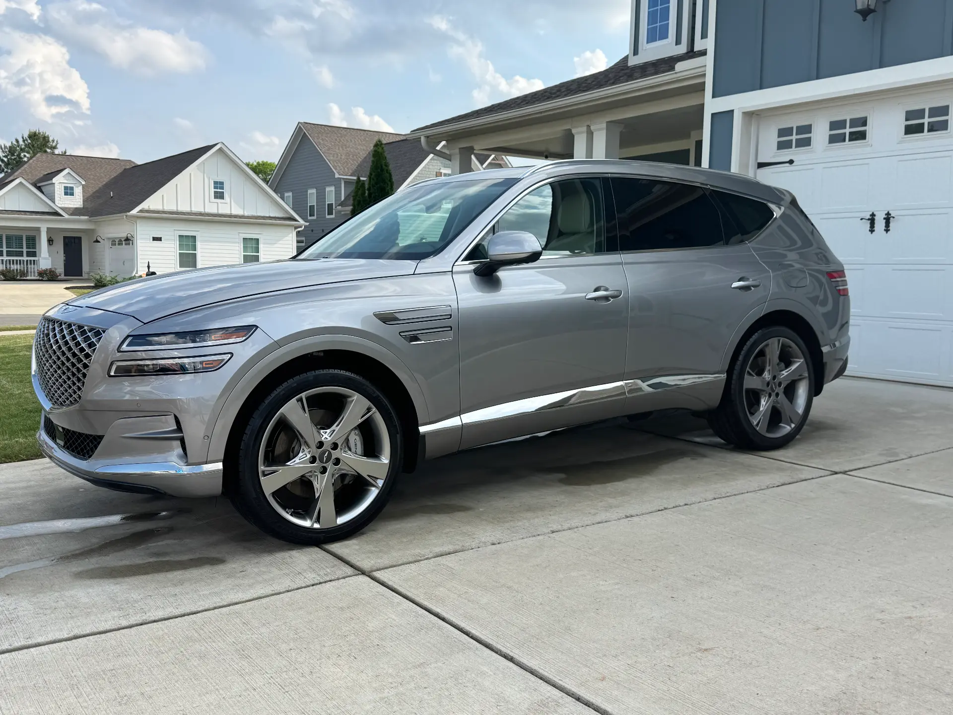 Silver Genesis GV80 SUV washed and waxed in a residential driveway