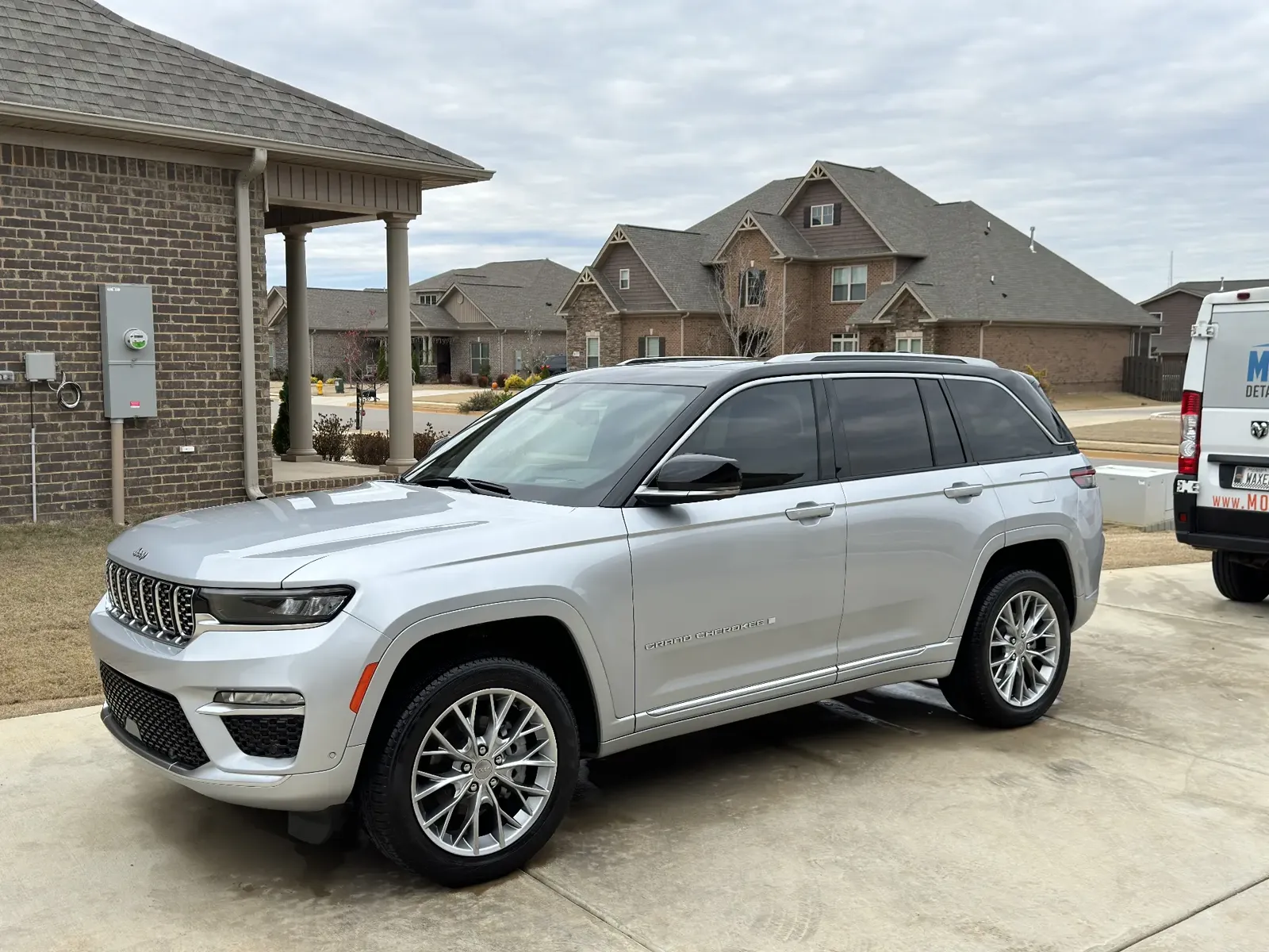 Mobile detailing on a silver Jeep Grand Cherokee Summit SUV in a driveway