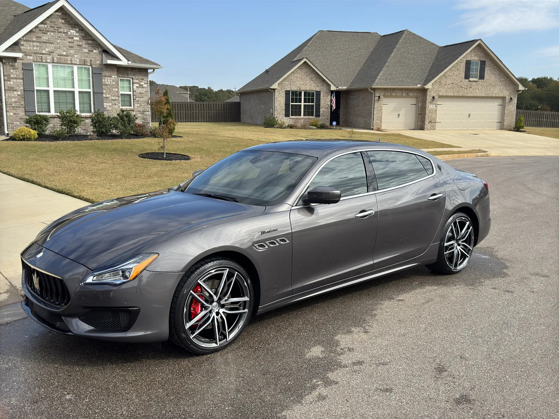 Grey Maserati Quattroporte detailed in front of a suburban home