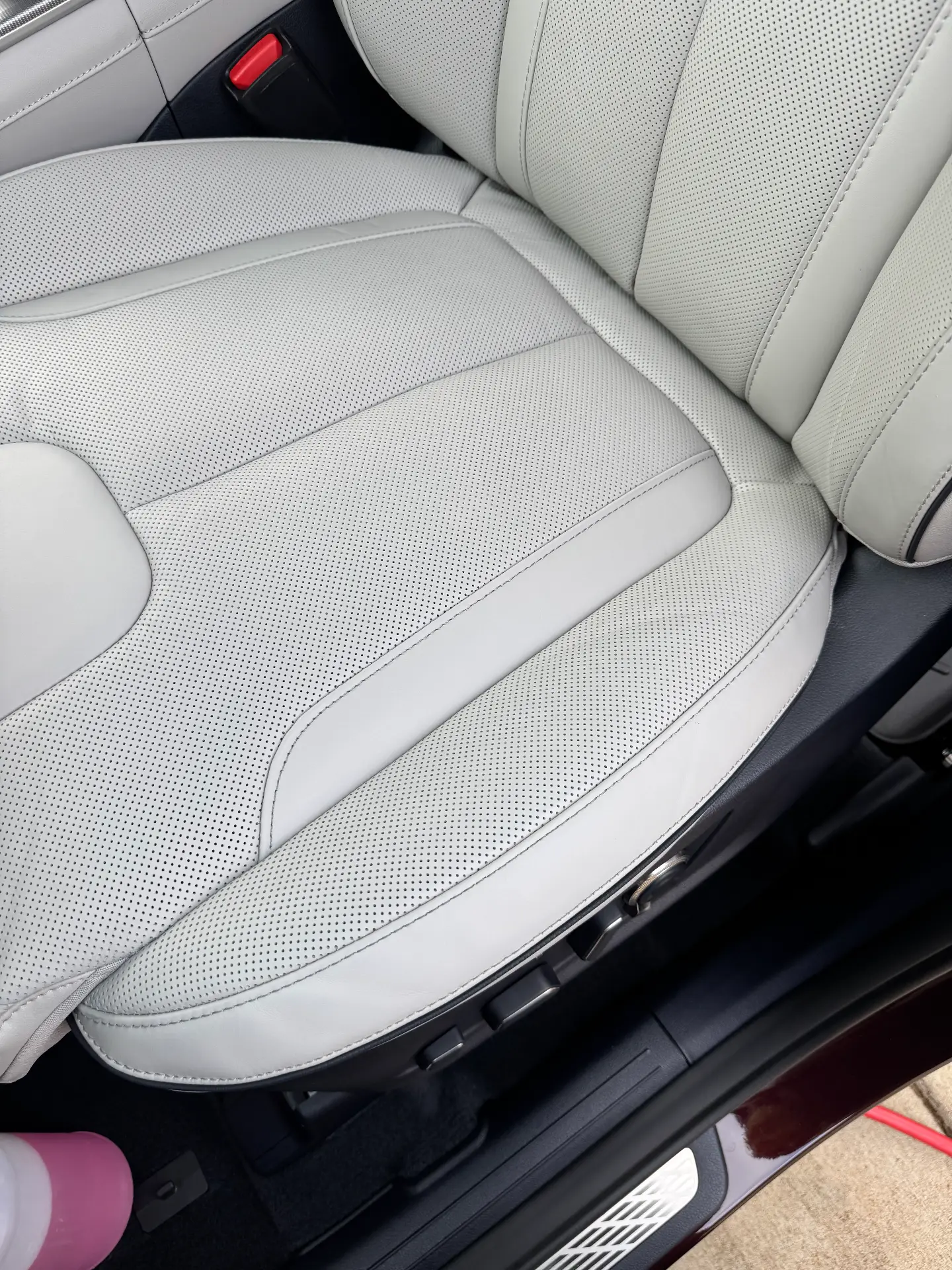 Light grey perforated leather seat cleaned and conditioned