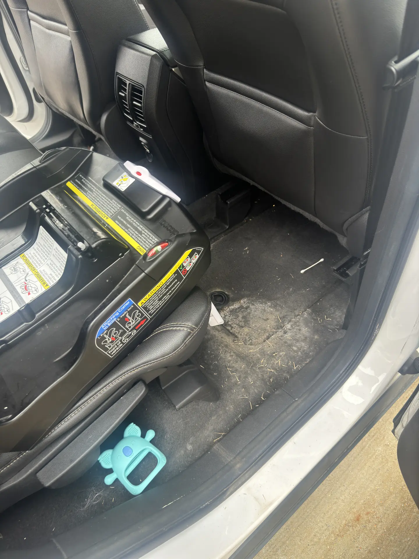 SUV rear floor with debris and stains before a full interior detail